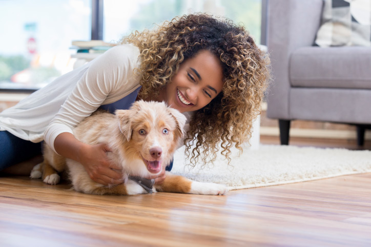 woman with her dog on the floor